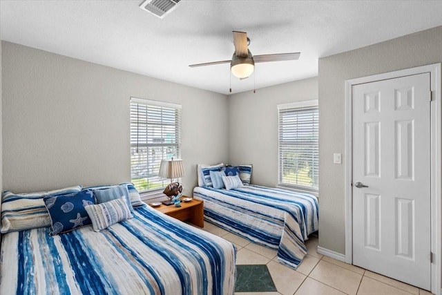 970 Gulfview Dr, Crystal Beach, TX 77650 - bedroom featuring light tile patterned flooring and a ceiling fan