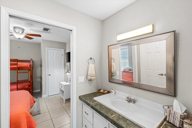 970 Gulfview Dr, Crystal Beach, TX 77650 - bathroom featuring vanity, tile patterned floors, a ceiling fan, baseboards, and ensuite bathroom