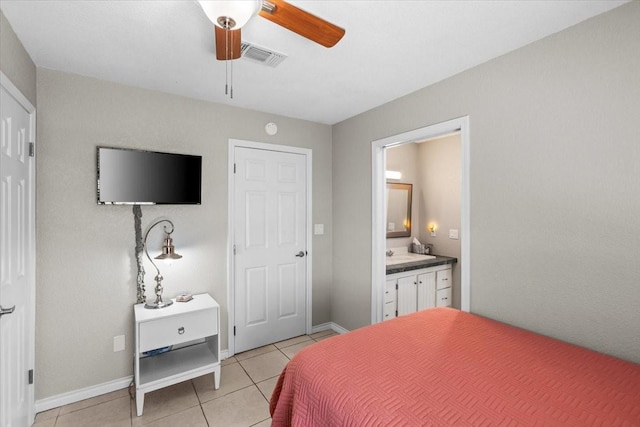 970 Gulfview Dr, Crystal Beach, TX 77650 - bedroom with light tile patterned floors, ensuite bathroom, baseboards, and ceiling fan