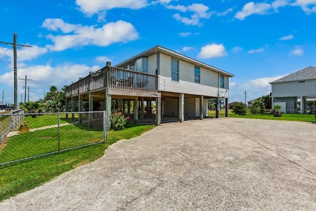 970 Gulfview Dr, Crystal Beach, TX 77650 - view of front of home with driveway, a deck, and a carport