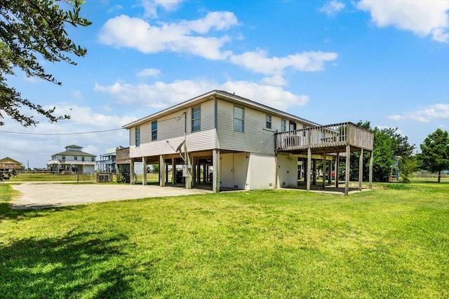 970 Gulfview Dr, Crystal Beach, TX 77650 - back of property featuring a carport, a wooden deck, driveway, and a lawn