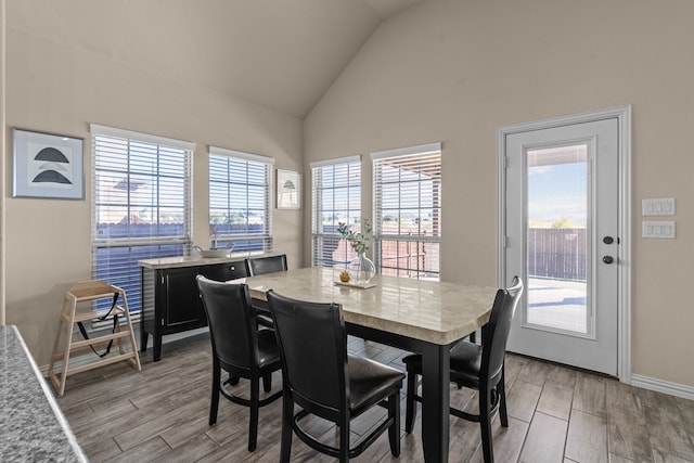 9212 Brittlebrush Trl, Fort Worth, TX 76177 - dining room featuring light wood-style flooring, high vaulted ceiling, and baseboards