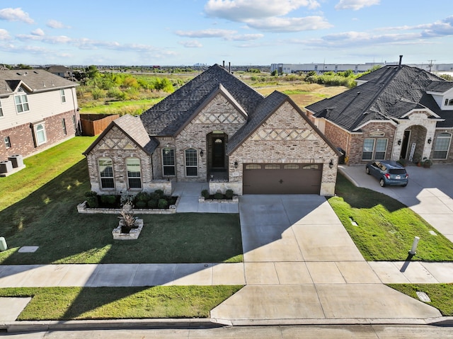 9212 Brittlebrush Trl, Fort Worth, TX 76177 - french provincial home with an attached garage, driveway, a front lawn, brick siding, and stone siding