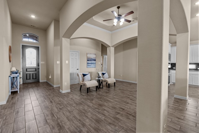 9212 Brittlebrush Trl, Fort Worth, TX 76177 - entrance foyer featuring a ceiling fan, dark wood finished floors, crown molding, arched walkways, and baseboards
