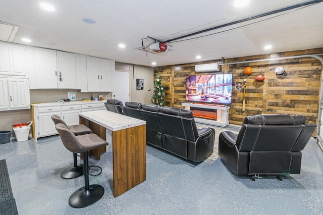1501 Raintree Ct, Grand Prairie, TX 75050 - living room with an AC wall unit, recessed lighting, and wood walls