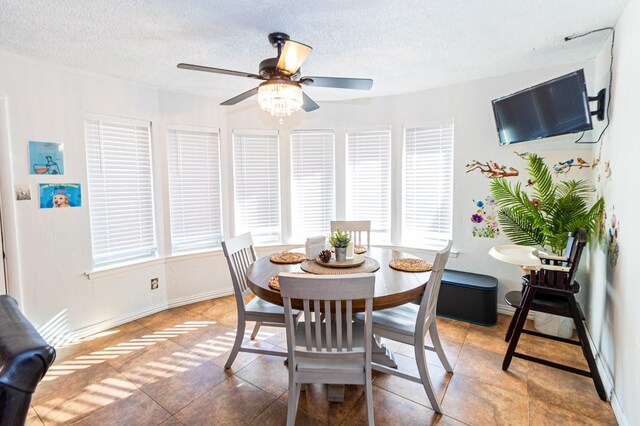 1501 Raintree Ct, Grand Prairie, TX 75050 - dining room featuring ceiling fan, a textured ceiling, baseboards, and light tile patterned floors