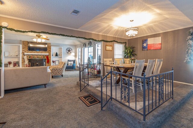 1501 Raintree Ct, Grand Prairie, TX 75050 - carpeted dining space featuring ornamental molding, a textured ceiling, a chandelier, a ceiling fan, and a fireplace
