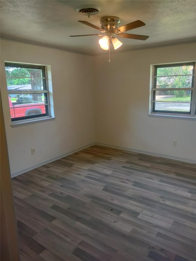 601 N 38th St, Corsicana, TX 75110 - unfurnished room featuring a ceiling fan, wood finished floors, a textured ceiling, and baseboards