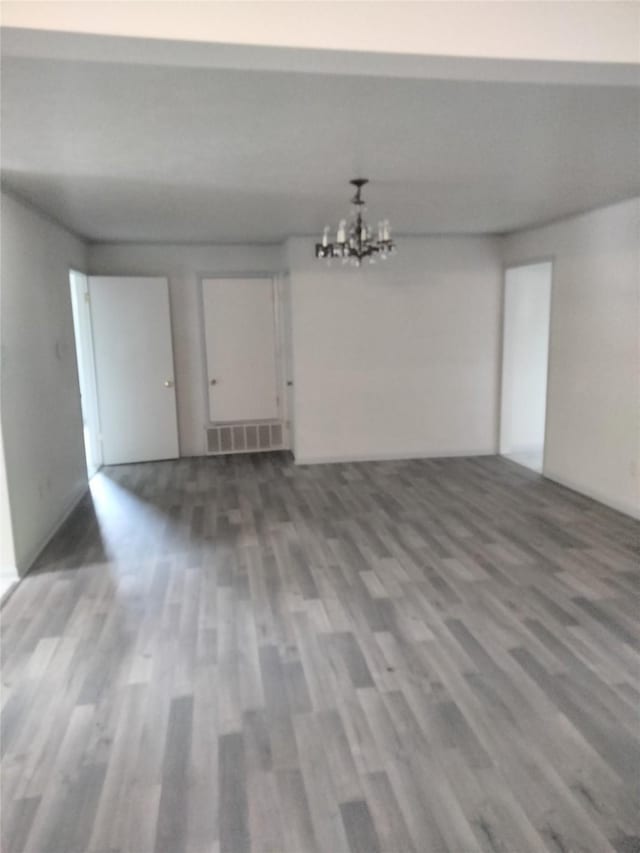 601 N 38th St, Corsicana, TX 75110 - unfurnished room with wood finished floors and a chandelier