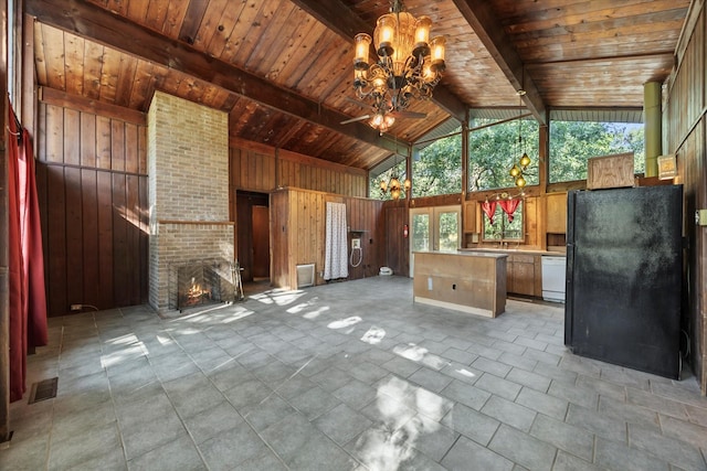 9598 Brockrim Ln, Quinlan, TX 75474 - unfurnished living room featuring wood walls, wood ceiling with exposed beams, high vaulted ceiling, a chandelier, and a fireplace