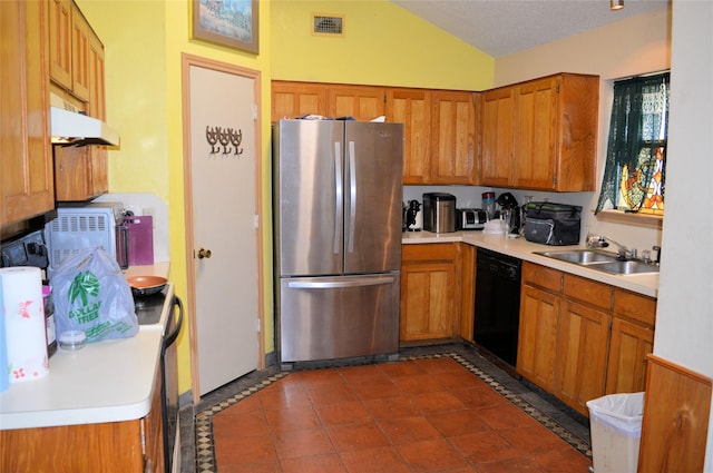 8109 Camelot Rd, Fort Worth, TX 76134 - kitchen featuring freestanding refrigerator, black dishwasher, a sink, lofted ceiling, and brown cabinetry