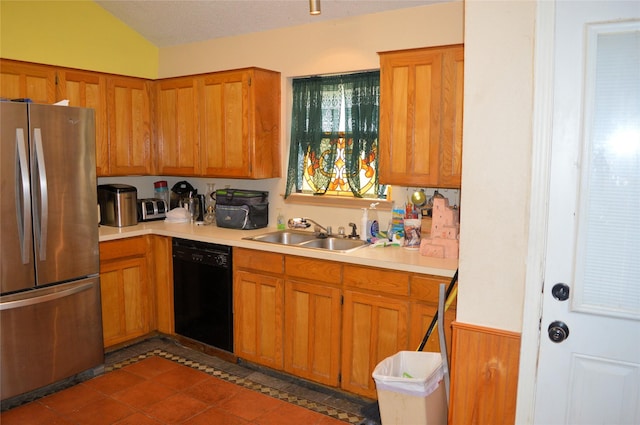 8109 Camelot Rd, Fort Worth, TX 76134 - kitchen with freestanding refrigerator, black dishwasher, a sink, light countertops, and brown cabinets