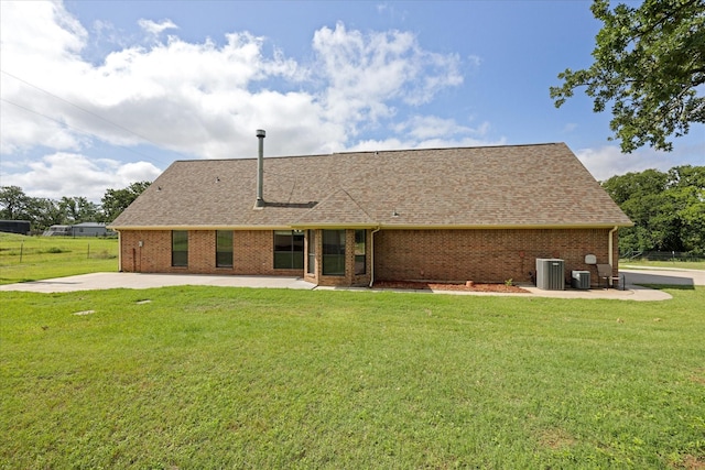 1511 Cabaniss Ln, Weatherford, TX 76088 - back of house with central air condition unit, brick siding, a shingled roof, and a patio area