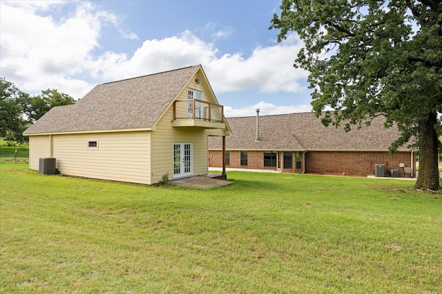 1511 Cabaniss Ln, Weatherford, TX 76088 - rear view of property featuring french doors, a shingled roof, a yard, central AC, and brick siding