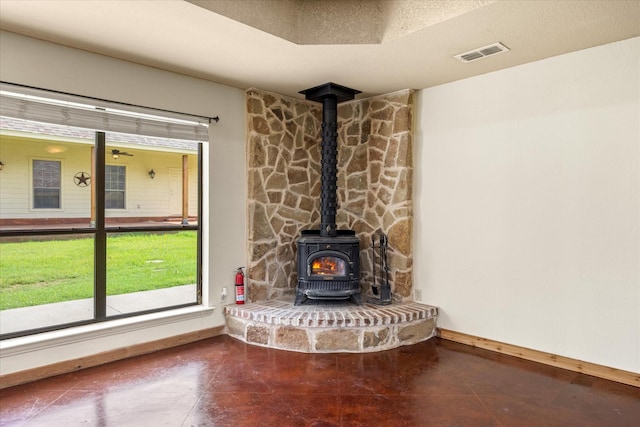 1511 Cabaniss Ln, Weatherford, TX 76088 - detailed view of a wood stove, a fire extinguisher, and baseboards