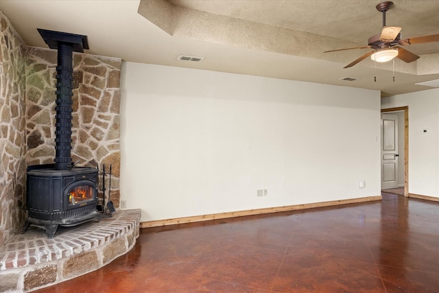 1511 Cabaniss Ln, Weatherford, TX 76088 - unfurnished living room with a wood stove, baseboards, a ceiling fan, and concrete floors