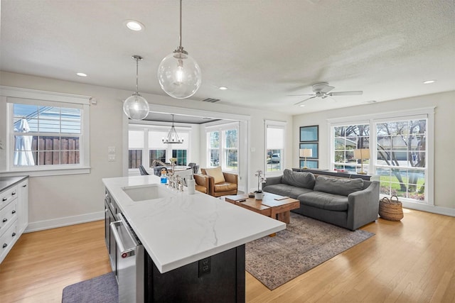 435 Allison Dr, Dallas, TX 75208 - kitchen with a sink, baseboards, an island with sink, stainless steel dishwasher, and recessed lighting