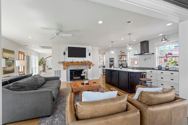 435 Allison Dr, Dallas, TX 75208 - living area with light wood-type flooring, a ceiling fan, recessed lighting, stairs, and a fireplace
