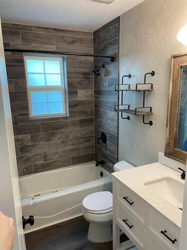 322 Cherry St, Weatherford, TX 76086 - full bathroom with toilet, vanity, wood finished floors, a textured wall, and shower / tub combination