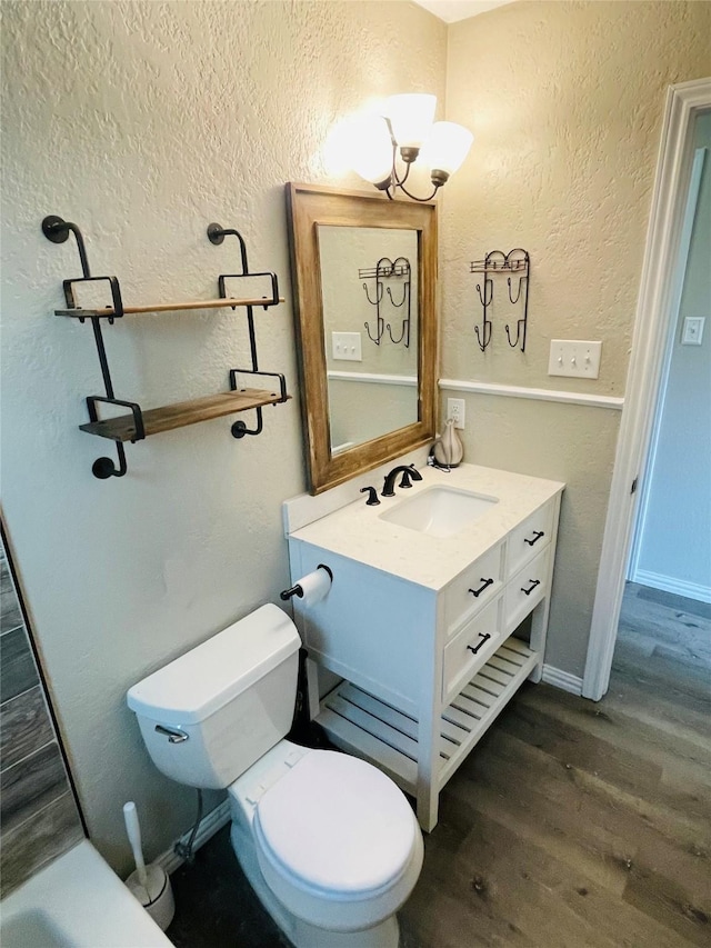 322 Cherry St, Weatherford, TX 76086 - bathroom with a textured wall, wood finished floors, vanity, and toilet