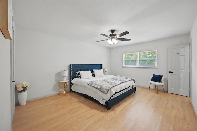 7201 Harwick Ln, North Richland Hills, TX 76182 - bedroom featuring light wood-style floors, a ceiling fan, and baseboards