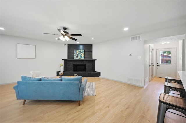 7201 Harwick Ln, North Richland Hills, TX 76182 - living room with ceiling fan, light wood-type flooring, recessed lighting, baseboards, and a brick fireplace