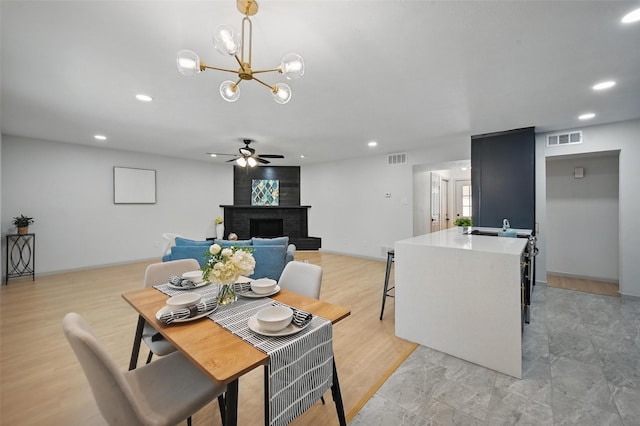 7201 Harwick Ln, North Richland Hills, TX 76182 - dining area with recessed lighting, a ceiling fan, a brick fireplace, and a chandelier