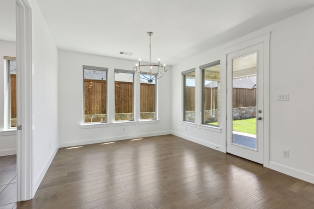 16431 Elk Hollow Rd, Frisco, TX 75035 - unfurnished dining area featuring a chandelier, baseboards, and dark wood-style floors