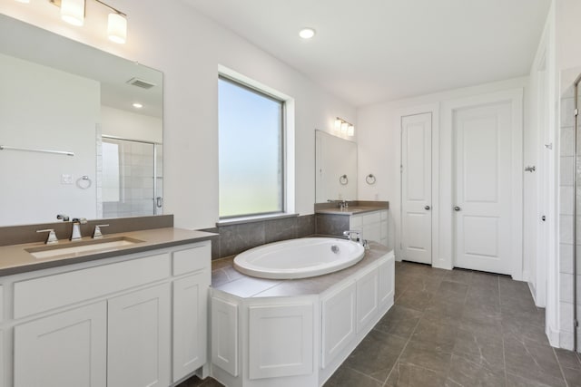 16431 Elk Hollow Rd, Frisco, TX 75035 - bathroom with two vanities, a garden tub, tiled shower, and recessed lighting