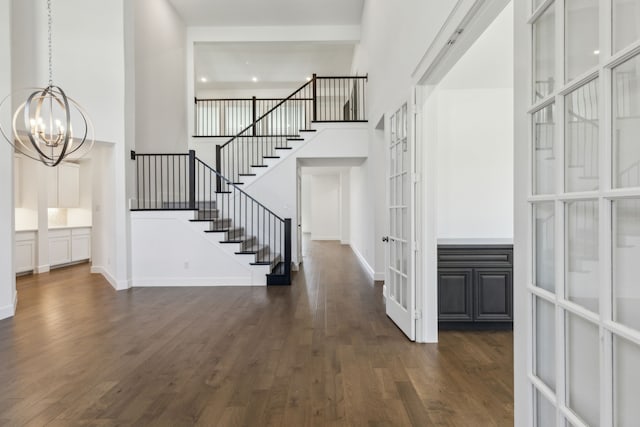 16431 Elk Hollow Rd, Frisco, TX 75035 - foyer featuring a towering ceiling, a chandelier, dark wood-style floors, french doors, and stairs