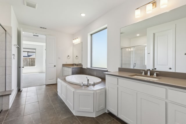 16431 Elk Hollow Rd, Frisco, TX 75035 - full bathroom with a shower stall, two vanities, a garden tub, recessed lighting, and tile patterned floors