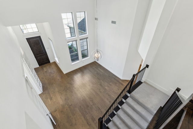 16431 Elk Hollow Rd, Frisco, TX 75035 - entryway featuring a high ceiling, a chandelier, wood finished floors, baseboards, and stairs
