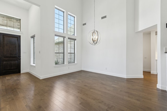 16431 Elk Hollow Rd, Frisco, TX 75035 - foyer with a high ceiling, a chandelier, plenty of natural light, and dark wood-style flooring
