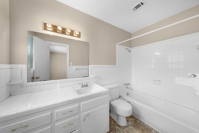1804 Posey Ln, Sulphur Springs, TX 75482 - full bathroom with toilet, vanity,  shower combination, tile walls, and wainscoting