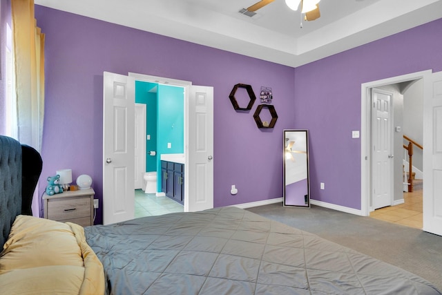 107 Oak Hollow Ln, Red Oak, TX 75154 - tiled bedroom with ensuite bathroom, carpet, baseboards, and ceiling fan