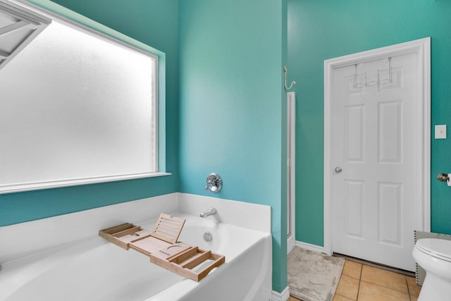 107 Oak Hollow Ln, Red Oak, TX 75154 - bathroom featuring a bath, toilet, tile patterned floors, and baseboards
