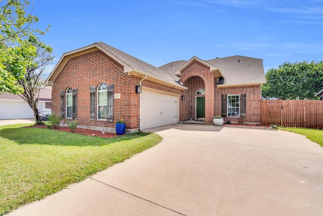 107 Oak Hollow Ln, Red Oak, TX 75154 - traditional home featuring brick siding, a garage, driveway, and roof with shingles