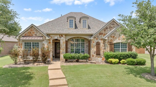 12341 Payne St, Frisco, TX 75033 - view of front of property featuring stone siding, a shingled roof, and a front lawn