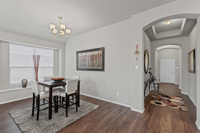 2101 Swenson Ranch Trl, Fort Worth, TX 76134 - dining space with arched walkways, dark wood finished floors, a chandelier, and baseboards