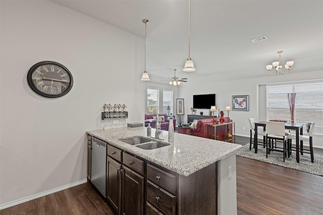 2101 Swenson Ranch Trl, Fort Worth, TX 76134 - kitchen featuring stainless steel dishwasher, a sink, dark brown cabinetry, dark wood finished floors, and plenty of natural light