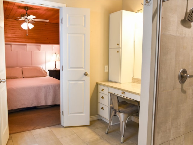 2226 Bethany Rd, Sherman, TX 75090 - full bathroom featuring a tile shower, tile patterned floors, ceiling fan, ensuite bathroom, and wooden walls