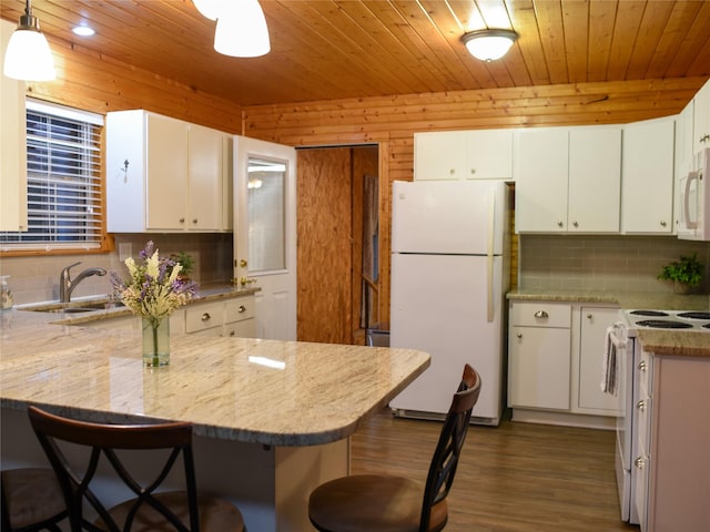2226 Bethany Rd, Sherman, TX 75090 - kitchen with white appliances, a peninsula, backsplash, a breakfast bar area, and wood ceiling