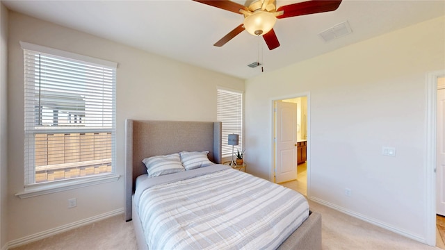 2753 Henson Ln, Garland, TX 75040 - bedroom with light carpet, baseboards, ensuite bathroom, and ceiling fan
