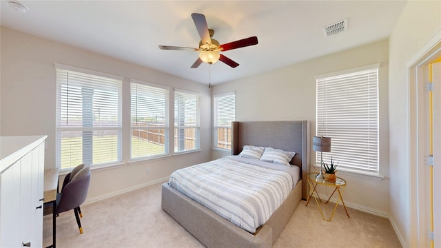 2753 Henson Ln, Garland, TX 75040 - bedroom with light colored carpet, baseboards, and ceiling fan