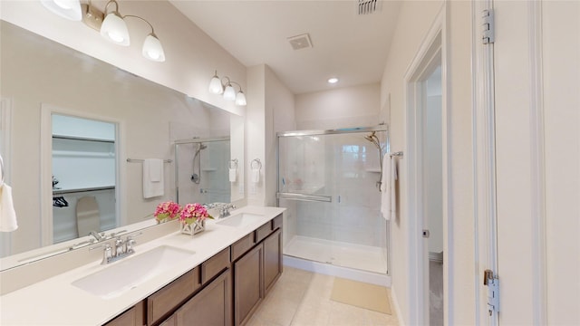 2753 Henson Ln, Garland, TX 75040 - bathroom with a stall shower, a walk in closet, double vanity, and tile patterned floors