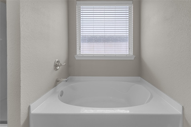 408 Prescott Ln, Fort Worth, TX 76036 - bathroom featuring a textured wall and a garden tub