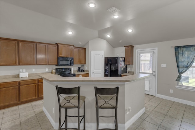 408 Prescott Ln, Fort Worth, TX 76036 - kitchen featuring black appliances, brown cabinets, a breakfast bar area, light countertops, and vaulted ceiling