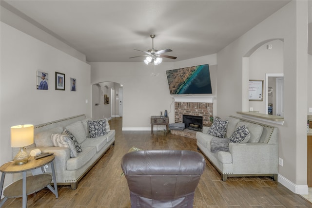 408 Prescott Ln, Fort Worth, TX 76036 - living room with arched walkways, a ceiling fan, wood finished floors, a fireplace, and baseboards