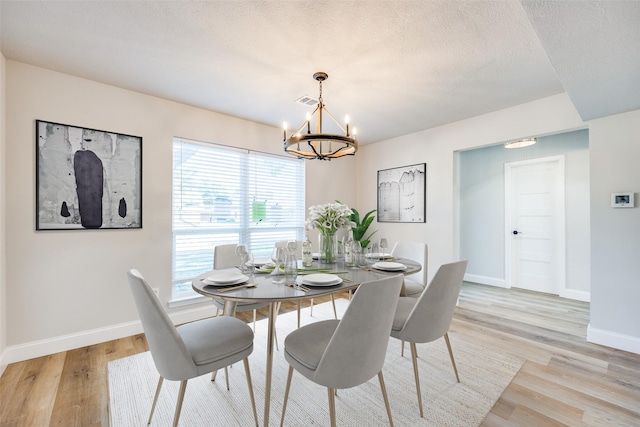 3414 Janlyn Ln, Farmers Branch, TX 75234 - dining area with a chandelier, baseboards, light wood finished floors, and a textured ceiling