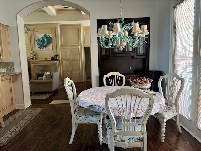 5812 Braemar Dr, Plano, TX 75093 - dining space featuring arched walkways, plenty of natural light, and dark wood-style flooring